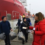 Foto Nicoloro G.   17/12/2024   Ravenna   E' approdata nel porto di Marina di Ravenna la nave Ocean Viking della ong Sos Mediterranee con a bordo 163 naufraghi. Di questi 100 sono uomini adulti , 9 donne delle quali una e' incinta e un' altra con un neonato, 21 sono minori non accompagnati e 33 minori di altrettanti nuclei famigliari..  I paesi di provenienza sono Afghanistan, Siria, Iran, Gambia ma anche Uzbekistan e Pakistan. nella foto alcune attiviste consegnano ad ogni migrante un foglietto con i numeri telefonici da contattare in caso di emergenza.